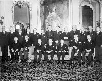 Viscount Alexander (seated, at centre) with former Prime Minister Mackenzie King and newly elected Prime Minister Louis St.-Laurent in a group photo of the Cabinet after the swearing-in ceremony at Rideau Hall. Date: November 15, 1948. Photographer: Unknown.   Reference: Library and Archives Canada, C-031308.